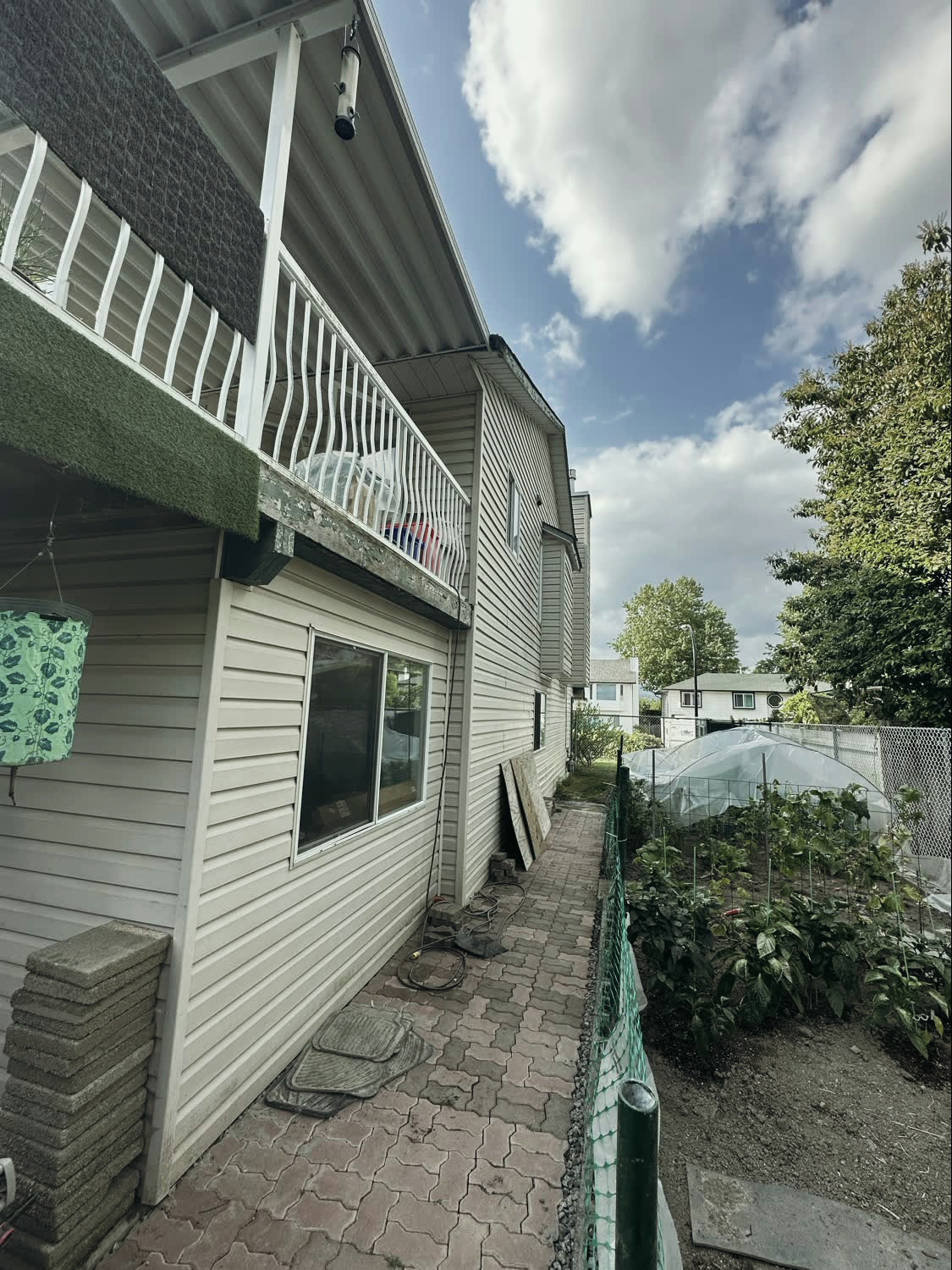The original raised deck, with white picket railing and worn artificial turf over the deck surface.