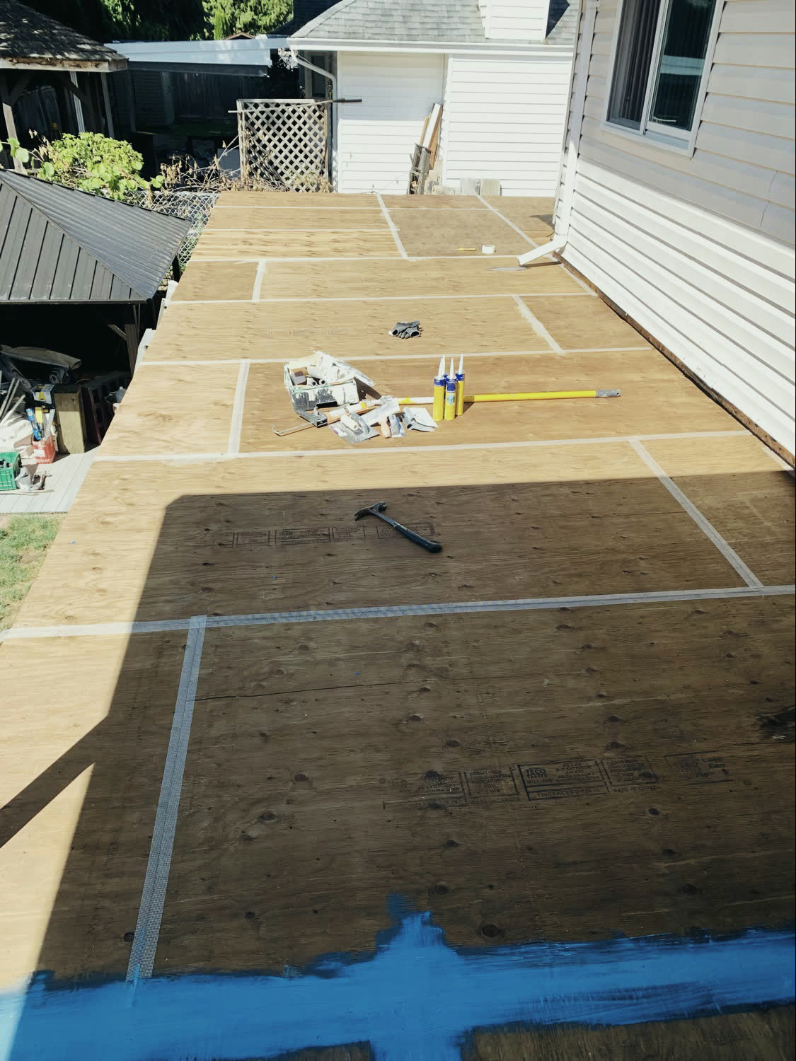 The rebuilt deck substrate sheeted in plywood and taped at the joints, ready for the finish surface.